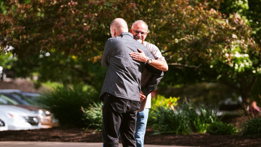 Two men greeting each other with an embrace