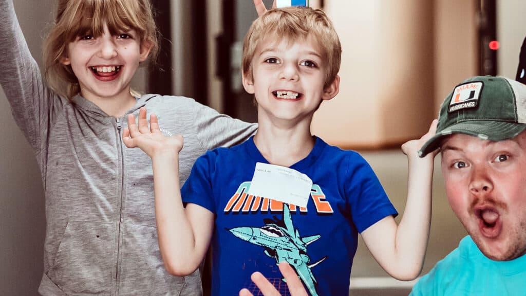 Two laughing boys and an adult volunteer making a silly face in the kids ministry at our Robinson, PA church campus.