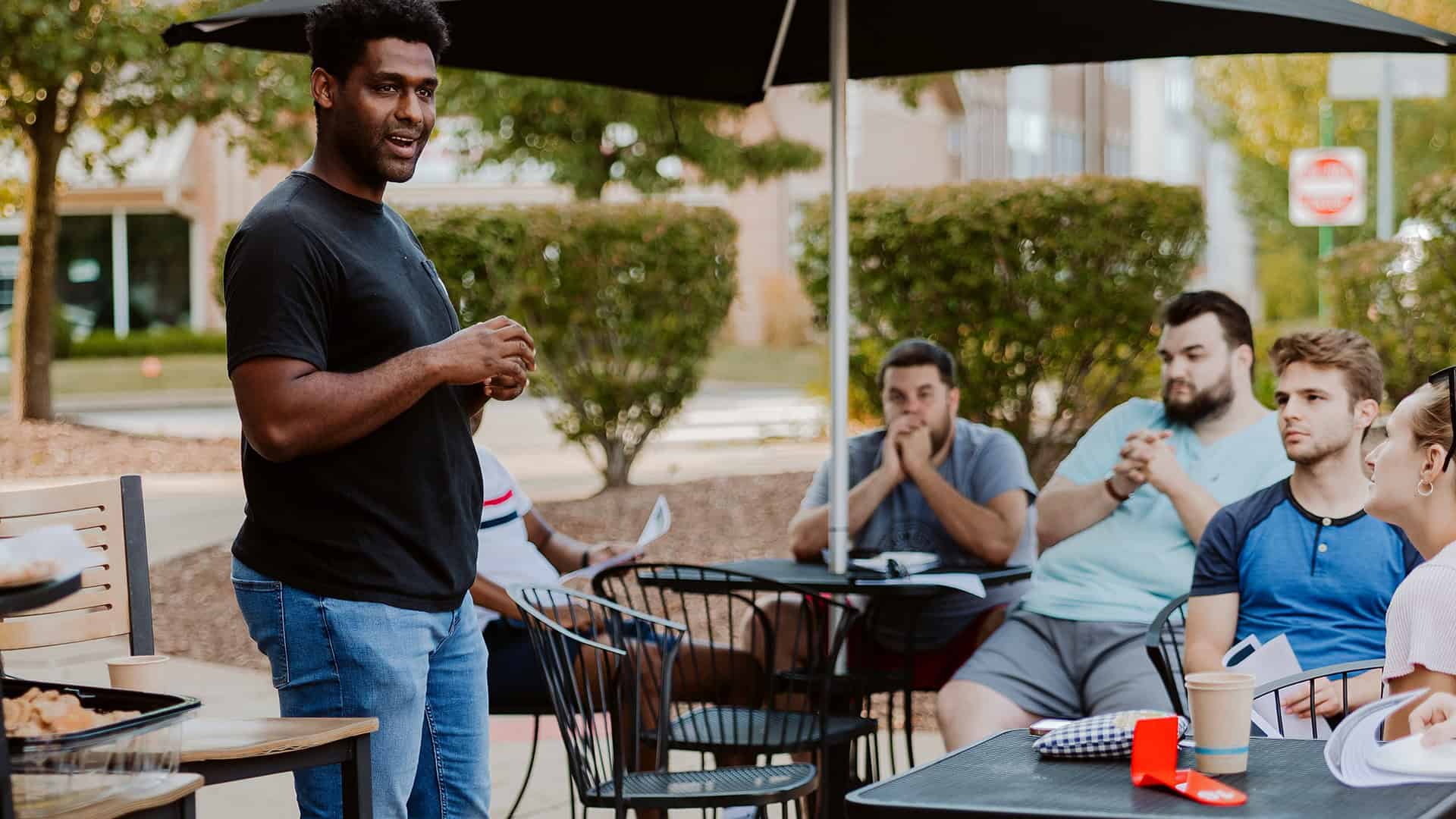 Young male adults listening to Abel Carleton at a 20/30s young adult gathering in Wexford PA
