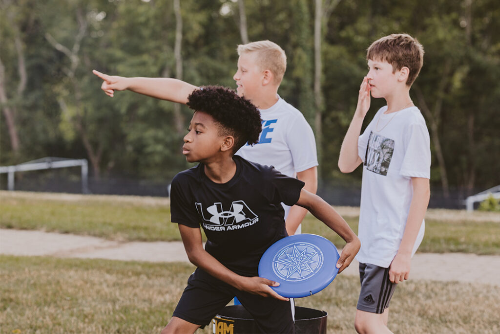 Student boys playing frisbee
