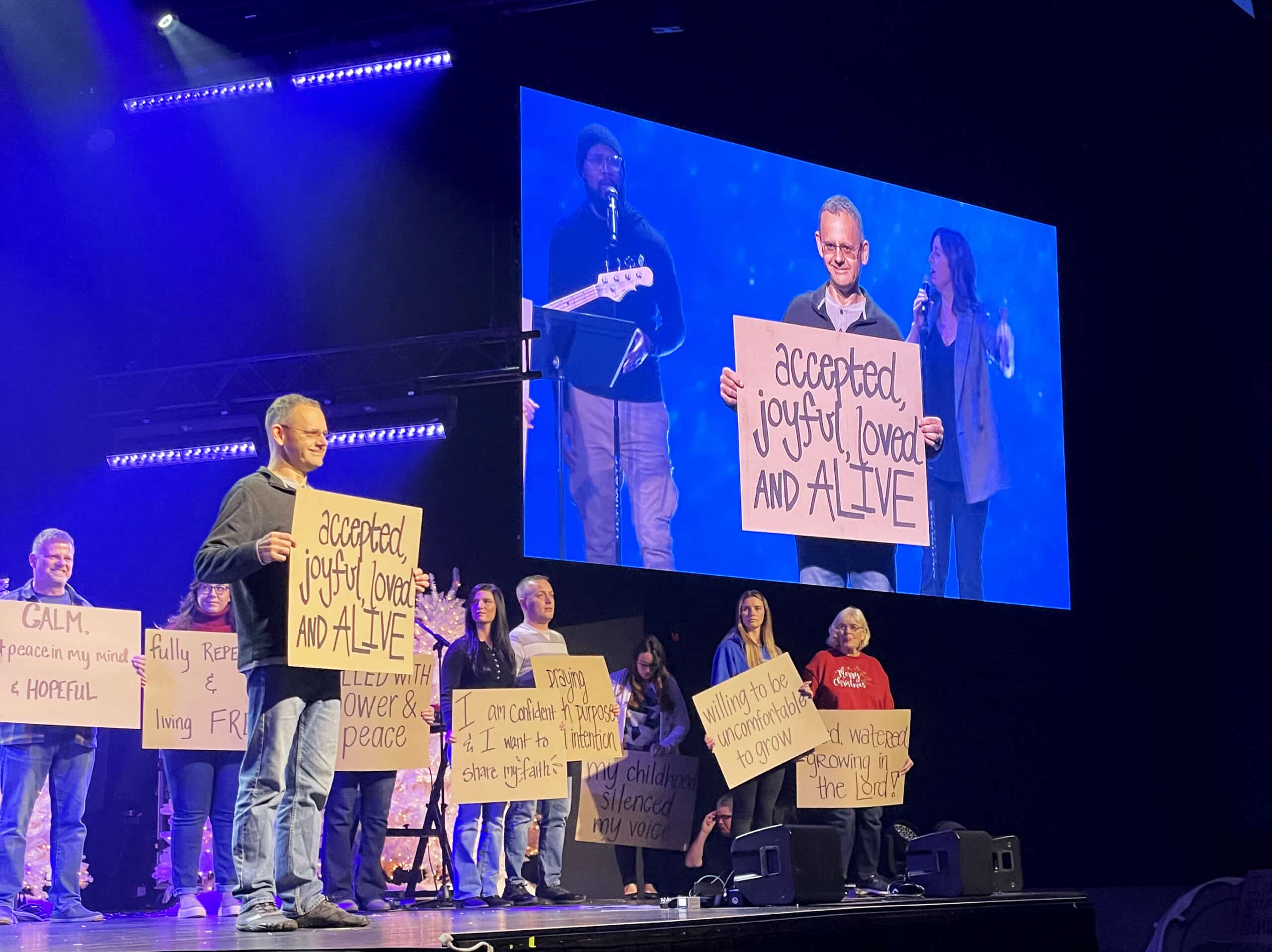 People on stage sharing their story and inviting others to know Jesus and get connected at with one of our Churches in Pittsburgh PA.