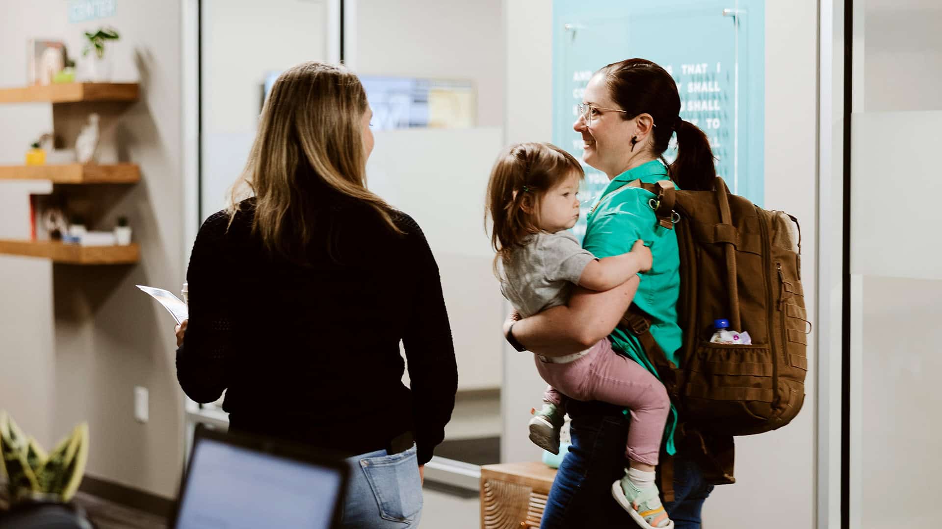A family checking into North Way Kids with Kids Ministry Director Jess Sherwood