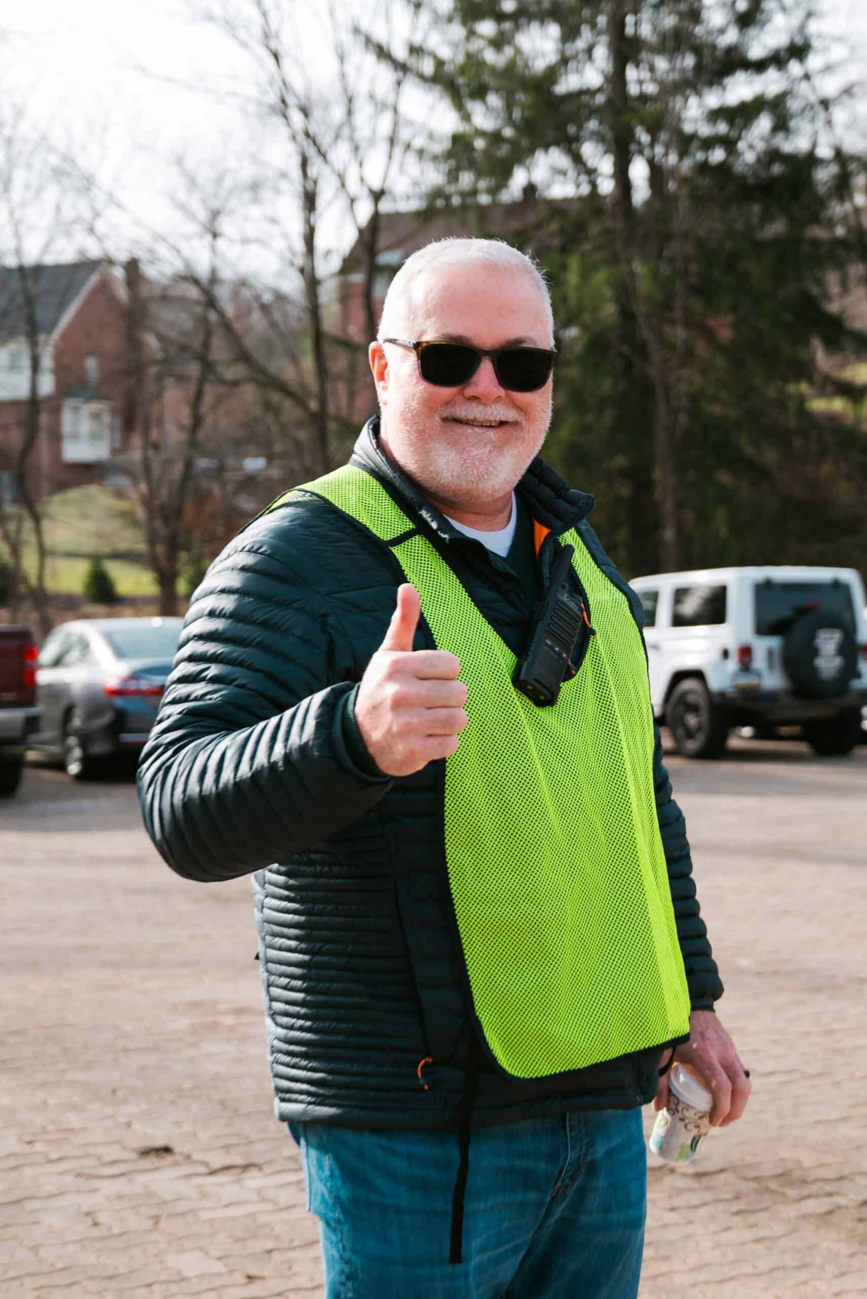 A South Hills parking volunteer greeting incoming cars at North Way Christian Community South Hills Campus