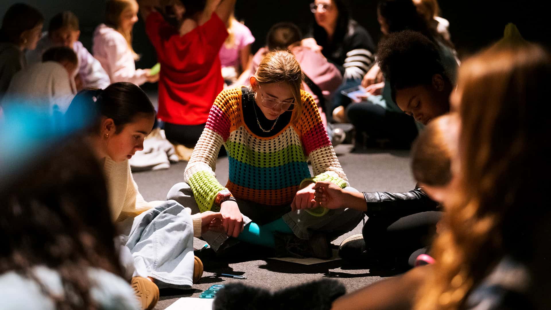 A young women's small group sitting on the floor