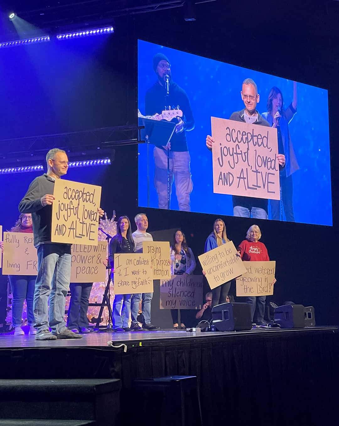 Rooted participants displaying testimony cards