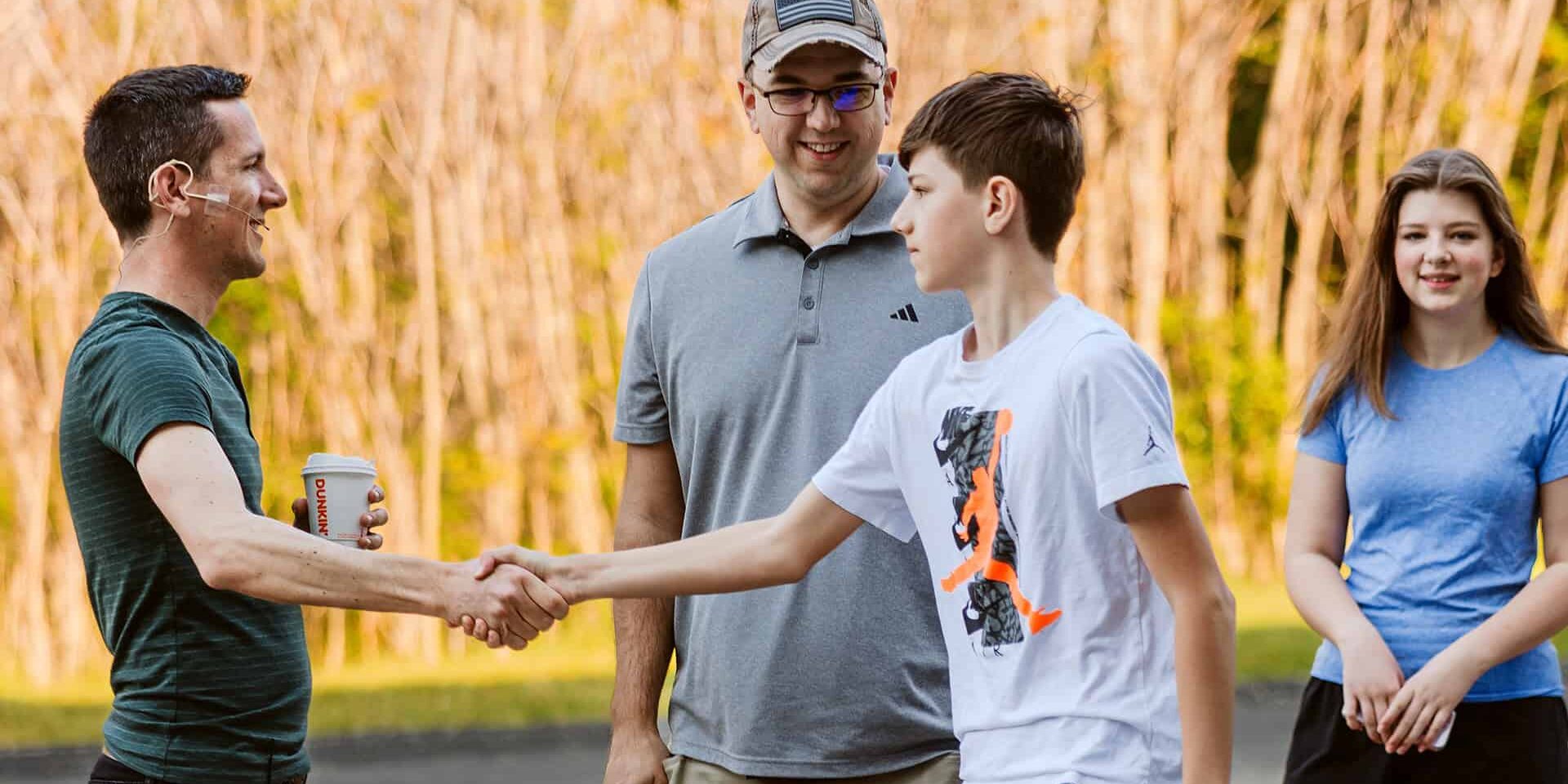 High school students being greeted by Gerin St Clair at a South Campus worship gathering