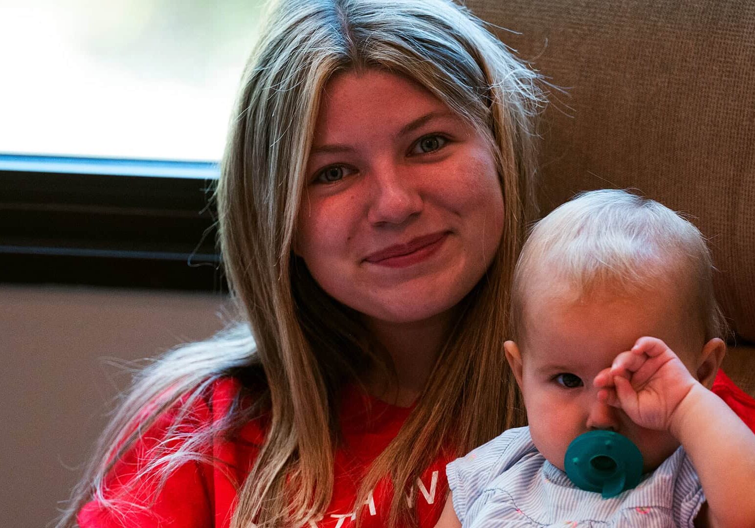 Kids Ministry volunteer holding a baby