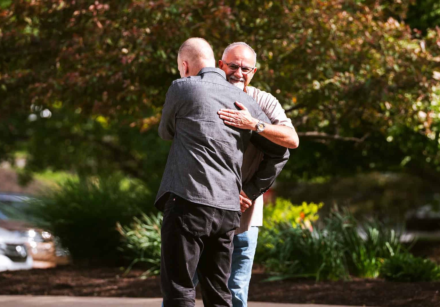 Two men greeting each other with an embrace