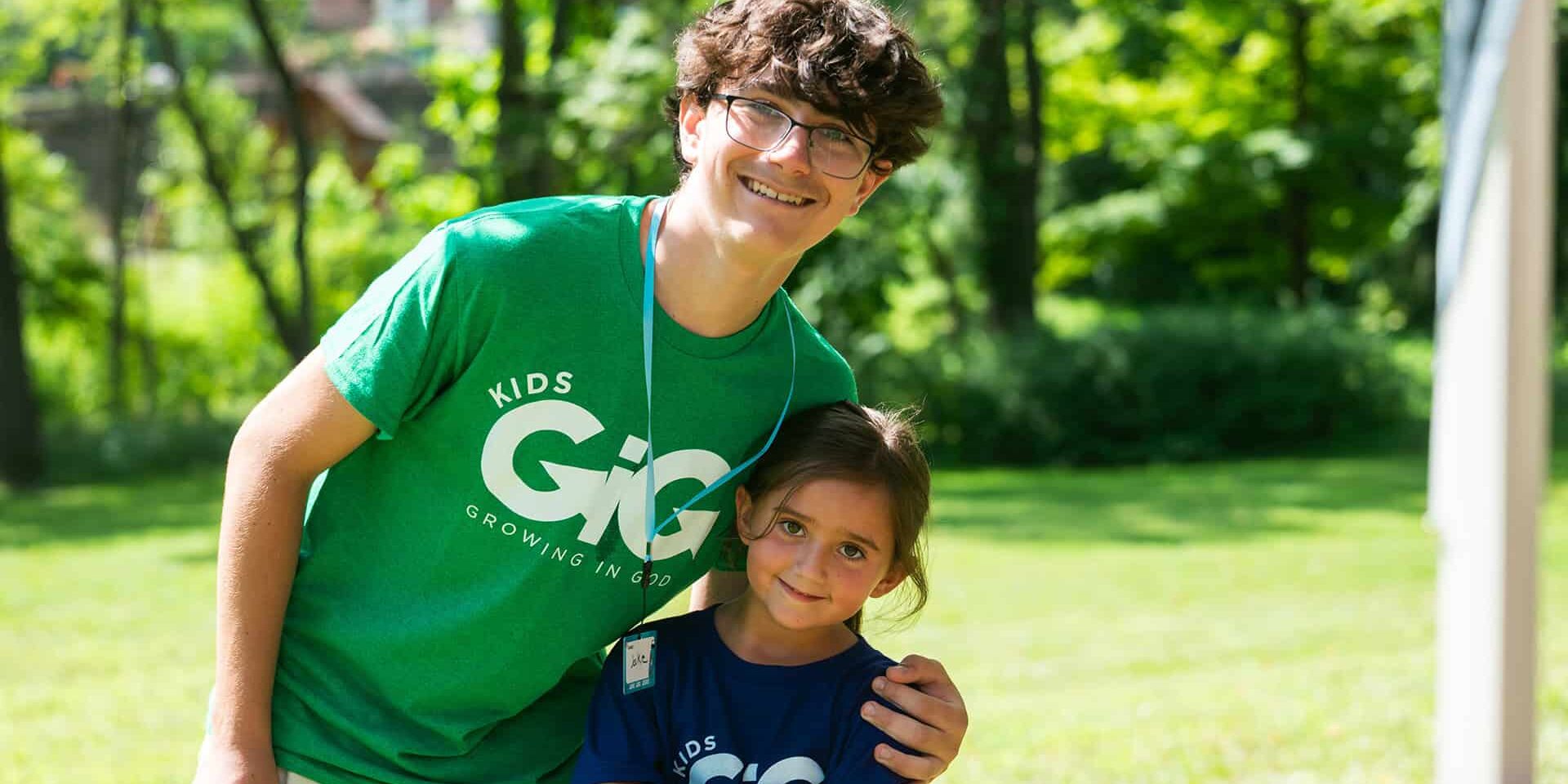 A student volunteer and camper smiling at the South Hills KidsGiG