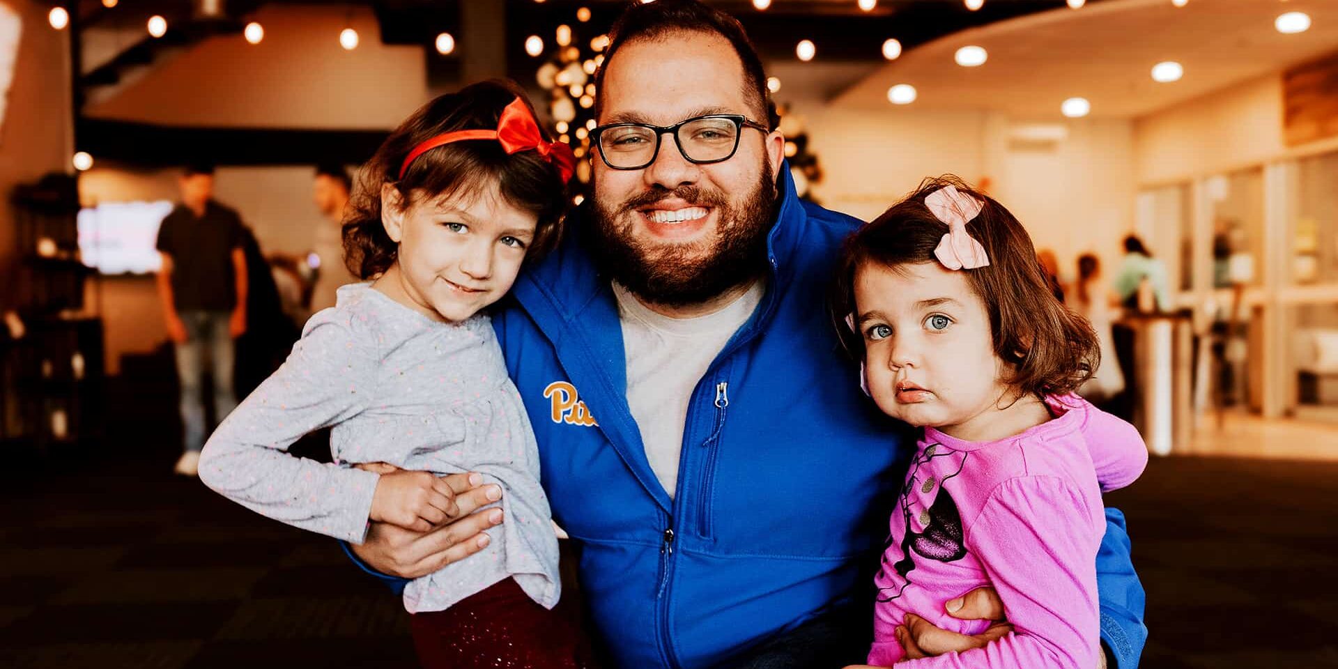 A father taking his daughters to North Way Sewickley Valley Kids Ministry.